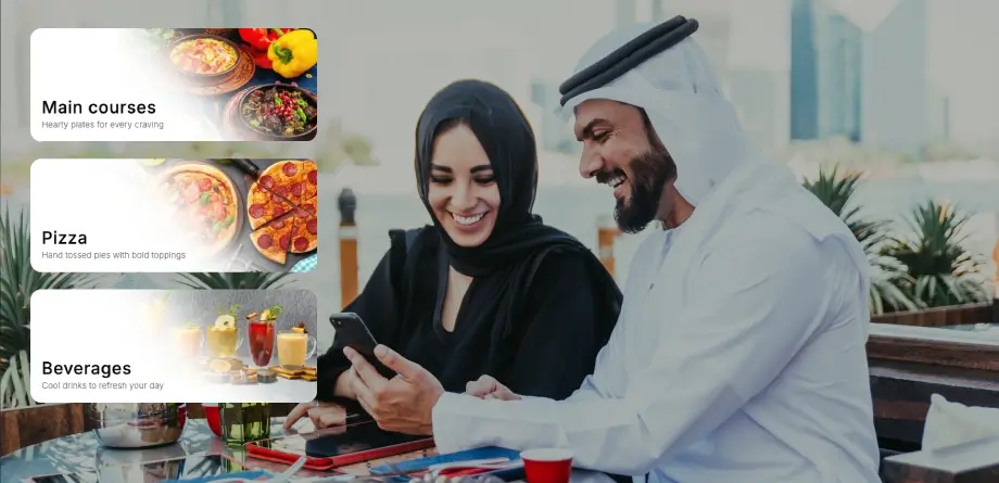 Emirati couple ordering from a TableQR digital menu at an outdoor UAE restaurant