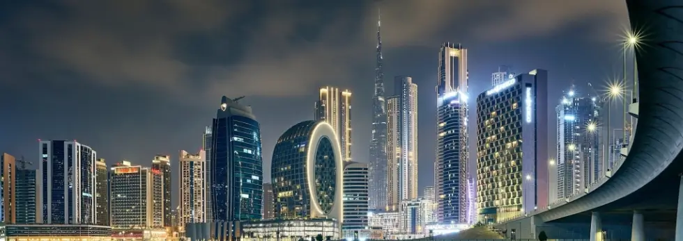 Dubai skyline with Burj Khalifa and city lights, showcasing smart hospitality and QR menus across the UAE