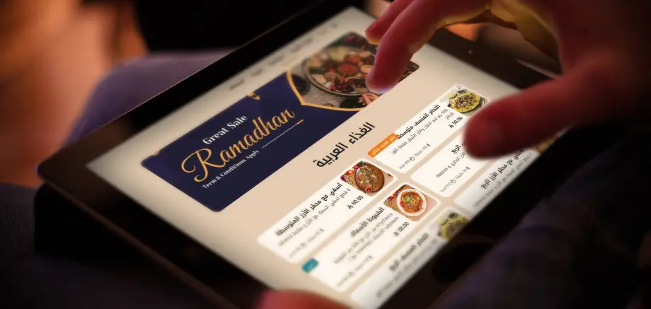 Customer browsing ramadan digital menu using restaurant tablet designed by TableQR