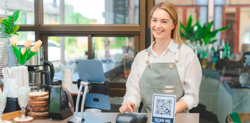 Waiter smiling at restaurant entrance and qr code placed at the bottle.