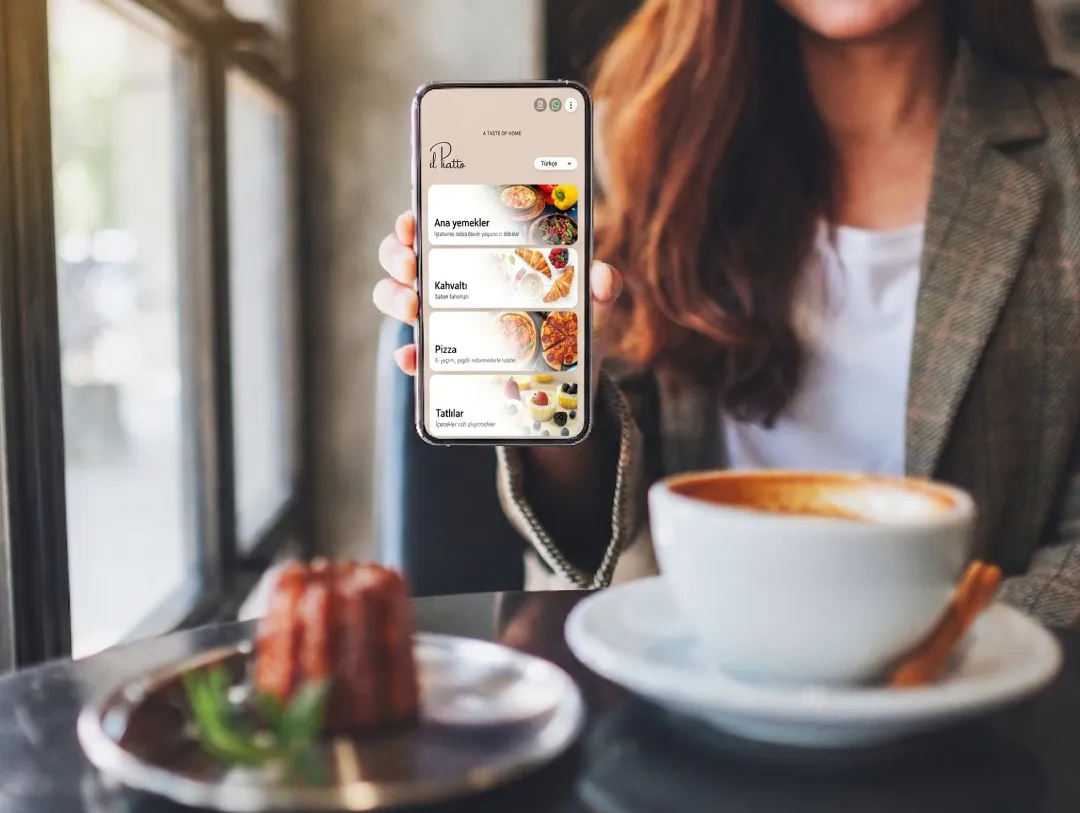 Guest at hotel holding phone displaying modern digital menu.
