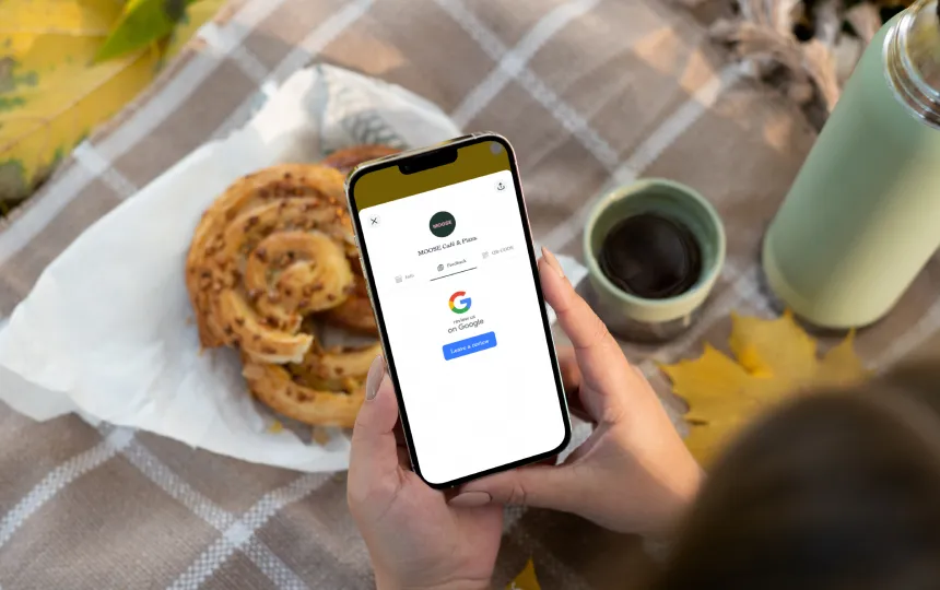 Girl holding phone with google review in display.
