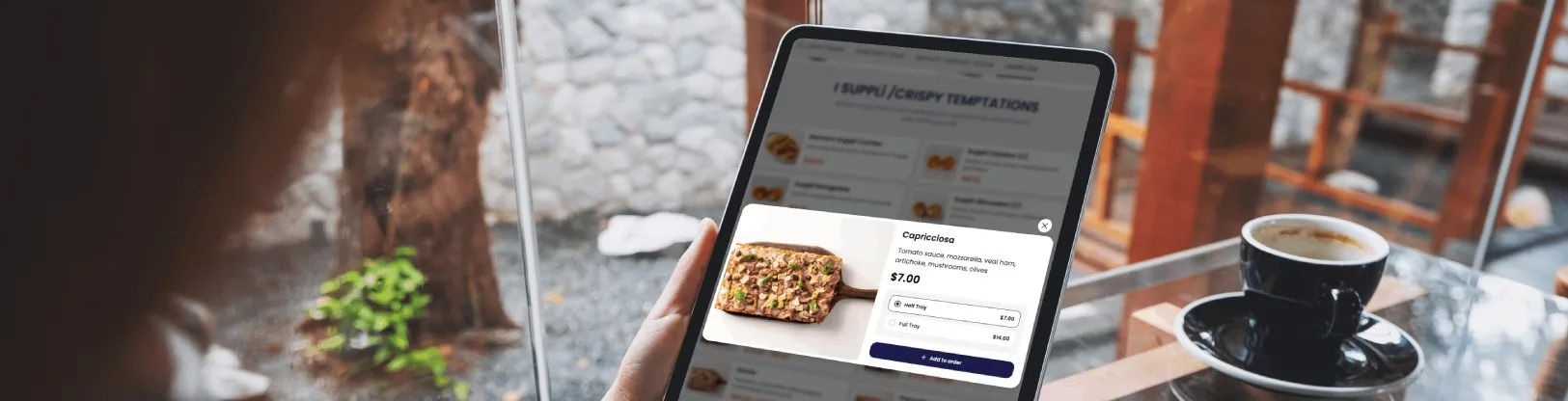 Guest browsing dishes and options on the restaurant tablet menu before the server takes the order
