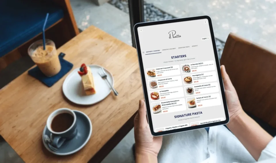 Guest reading the restaurant tablet menu at the table before ordering with the server