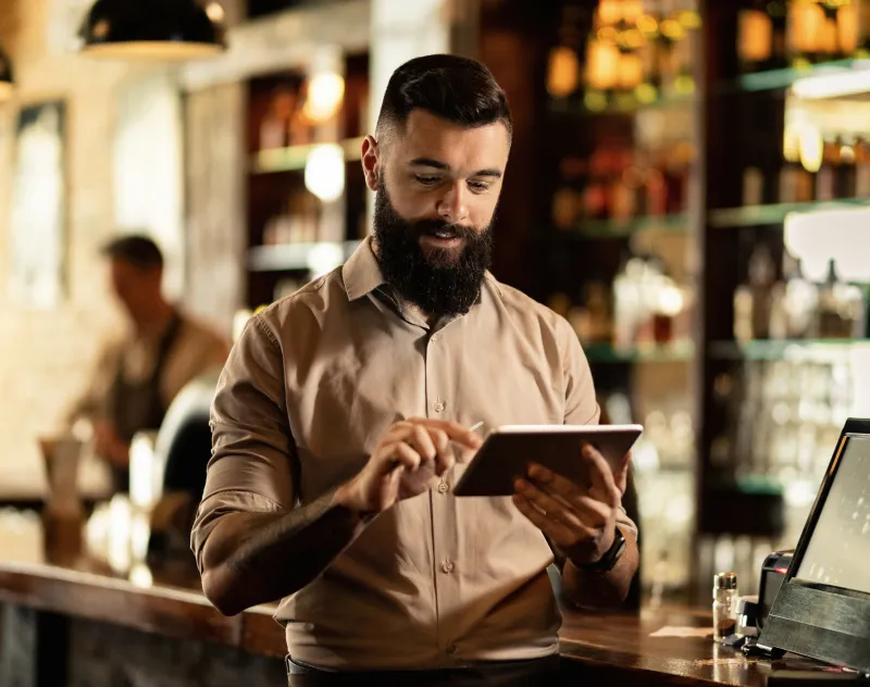 Manager updating a dish price on the tablet menu, live across every tablet in the restaurant